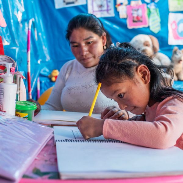 Meleyde performs the speech therapy she learned at CMMBs Rehabilitation with Hope Project to her daughter Rosalinda, diagnosed with infantile cerebral palsy and cardiomegaly, at her home