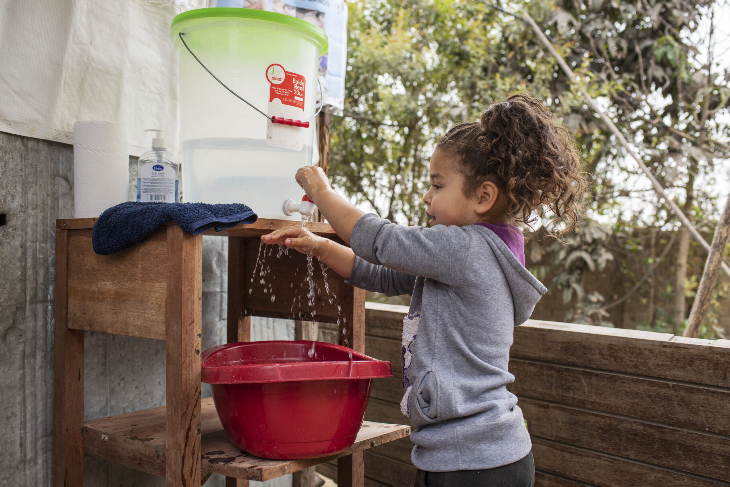 Kid washes her hands