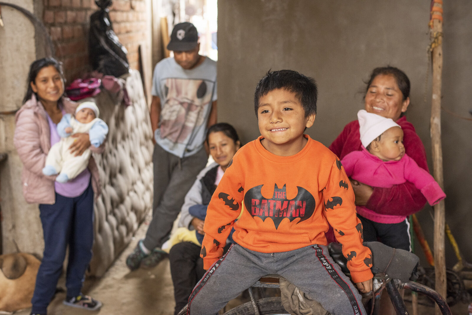 Kid with his family before receiving medication from the CHAMPS Project