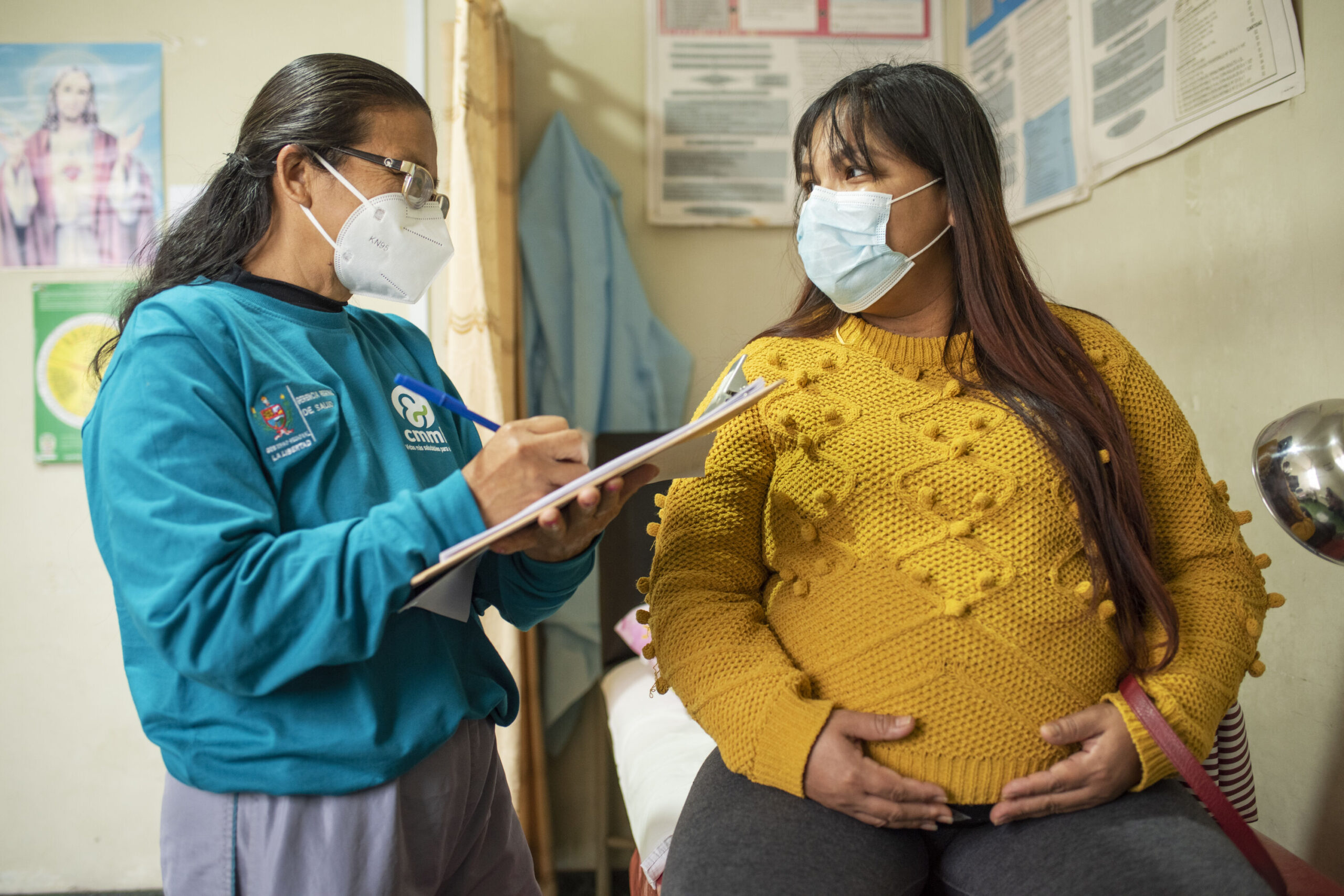 Community Health Agent Charo Soto takes the details of pregnant mother